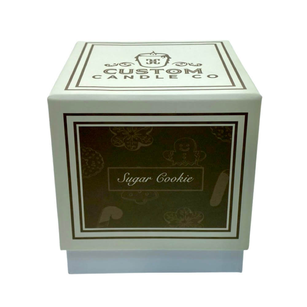 A white box labeled "Custom Candle Co" and "Sugar Cookie" holds the Holiday Scented Boxed Candle – Sugar Cookie Scent, a soy wax candle with a festive sugar cookie aroma.
