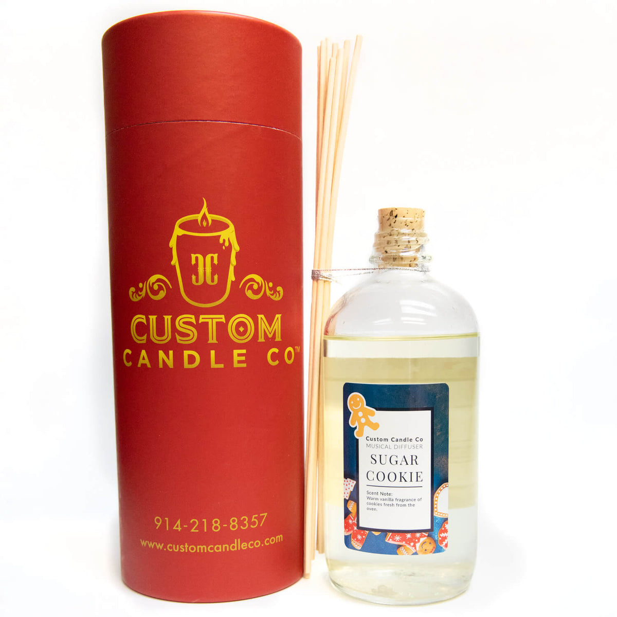 The Musical Holiday Candle & Diffuser | Sugar Cookie features a sugar cookie scent, fragrance oil, wooden reeds, and festive red packaging—perfect for bringing a holiday candle feel to your home.
