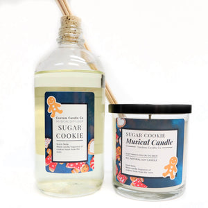 The Musical Holiday Candle & Diffuser | Sugar Cookie, featuring blue labels and gingerbread man art, are displayed side by side against a white background.