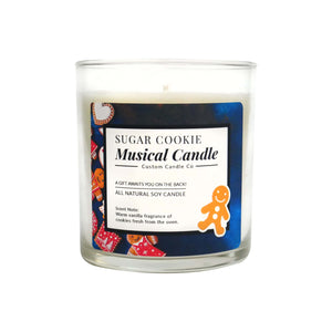 The "Musical Holiday Candle – Sugar Cookie" is a glass jar soy candle with gingerbread images, warm vanilla scent notes, and festive music—ideal for fans of scented holiday candles and Musical Christmas candles.