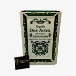 The Recycled Ceramic Tequila Candle – Flat Cut features a rectangular ceramic bottle with green patterns, made from coconut-apricot wax for sustainability, and comes with a black "Custom Candle Co." matchbox.