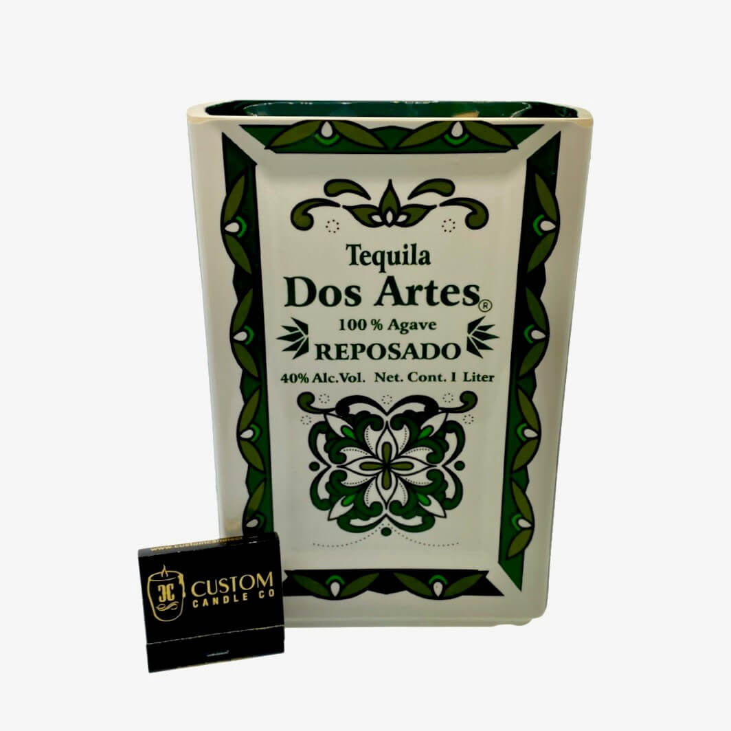 The Recycled Ceramic Tequila Candle – Flat Cut features a rectangular ceramic bottle with green patterns, made from coconut-apricot wax for sustainability, and comes with a black "Custom Candle Co." matchbox.