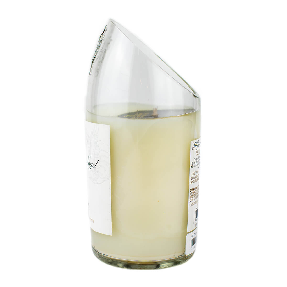 The Recycled Champagne Candle is a hand-poured white soy candle in a clear glass vessel, featuring a slanted, broken rim and partially peeled labels.