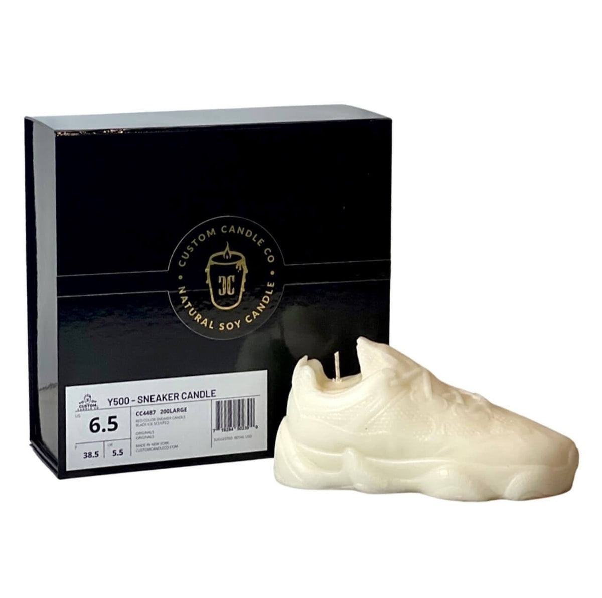 The Y500 – White Sneaker Candle – Large (On Backorder) is shown before a "Custom Candle Co Natural Soy Candle" black box. This hand-poured candle fills your space with the refreshing Black Ice fragrance.