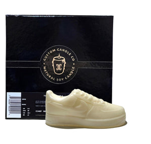 The AF1 – White Lowtop Sneaker Candle – Small (On Backorder) is showcased before a black Custom Candle Co. Natural Soy Candle box, emphasizing its handcrafted design and sneaker-inspired look.
