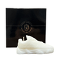 The Y500 – White Sneaker Candle – Small (On Backorder) is a hand-poured, natural soy candle shaped like a white sneaker, presented in front of a black "Custom Candle Co." box and features a refreshing Black Ice fragrance.