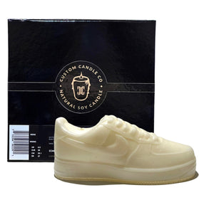 The AF1 – White Lowtop Sneaker Candle – Large (On Backorder) is a sneaker-shaped candle in fresh Black Ice fragrance, shown before a black Custom Candle Co. box labeled "Natural Soy Candle.